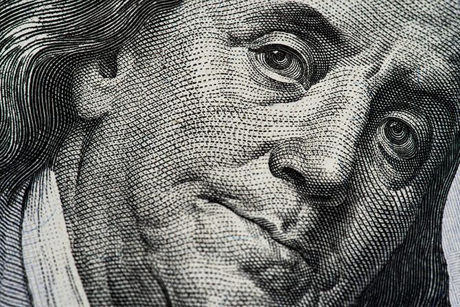 Closeup of Benjamin Franklin's face on the 100 Dollar bill showing the intricate details that make up the texture of the image.
