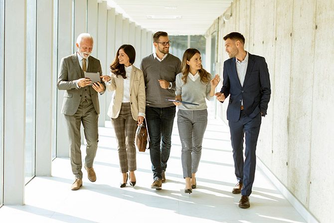 Group of professoinals walking down a hallway