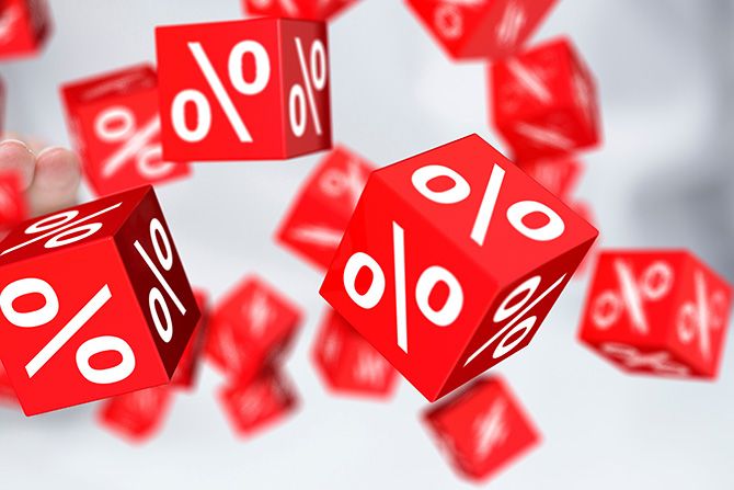 Member Discounts & Special Pricing; Red cubes with white percentage symbols float against a blurred background, suggesting concepts of discounts or interest rates. Dynamic and engaging tone.