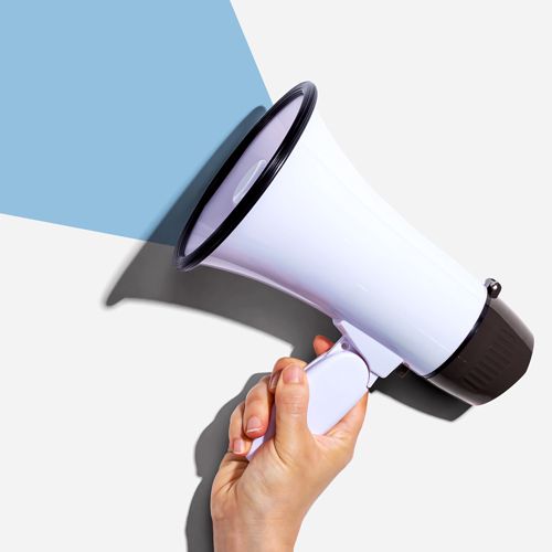 State Board Report: Announcing a New Appointment and Transition; A hand holds a white megaphone against a light gray background, projecting a blue triangular shadow. The image conveys a sense of communication and amplification.